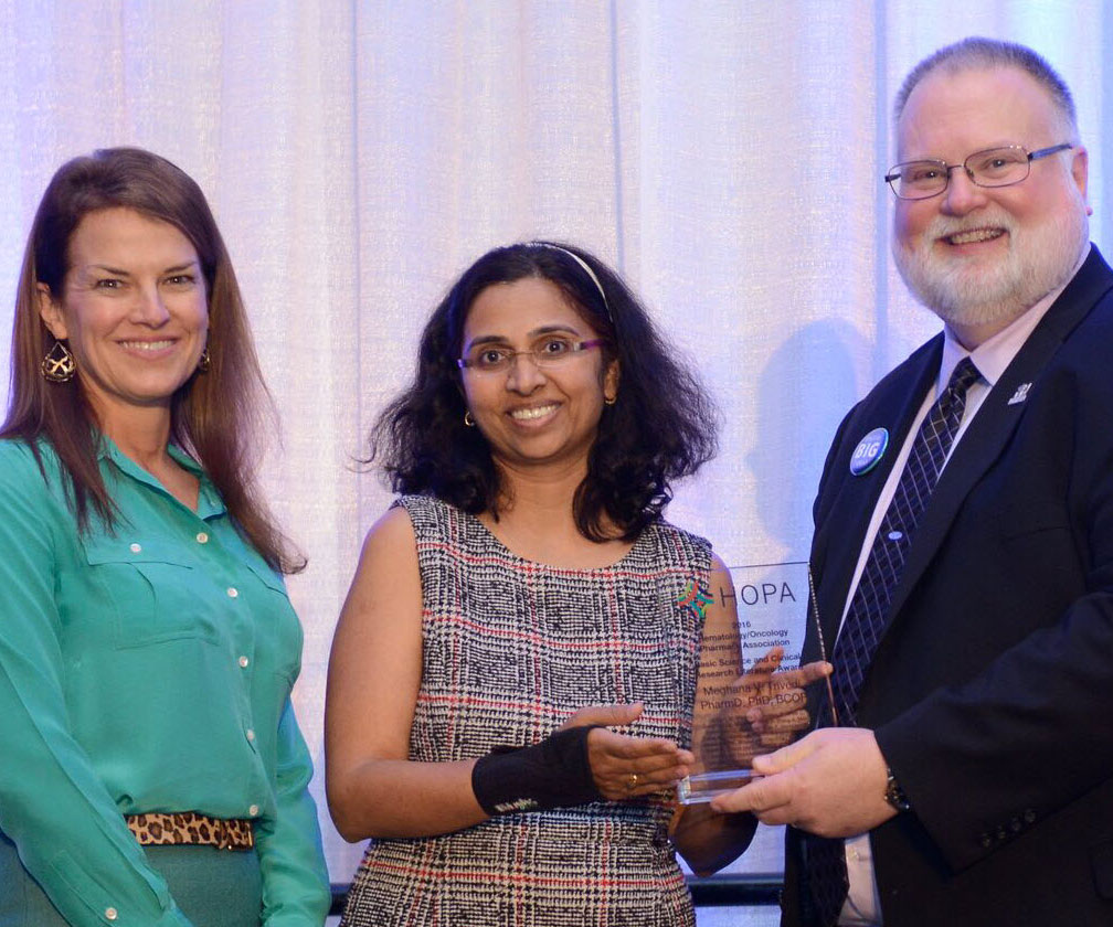 HOPA Awards and Recognition Program image of award presentation with two women and one man
