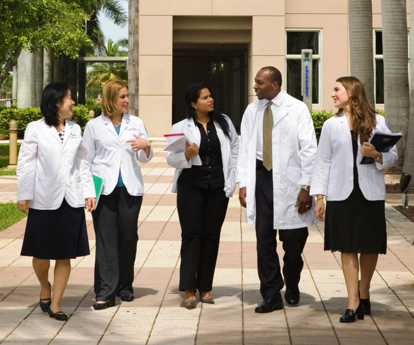 HOPA Recruit a Colleague Program image of pharmacists in white coats talking