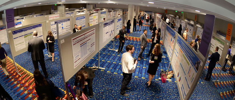 HOPA Research image of people in exhibit hall discussing poster exhibitis